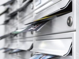 modern mailboxes filled of leaflets