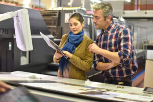 printing professionals examine proofs in a printing